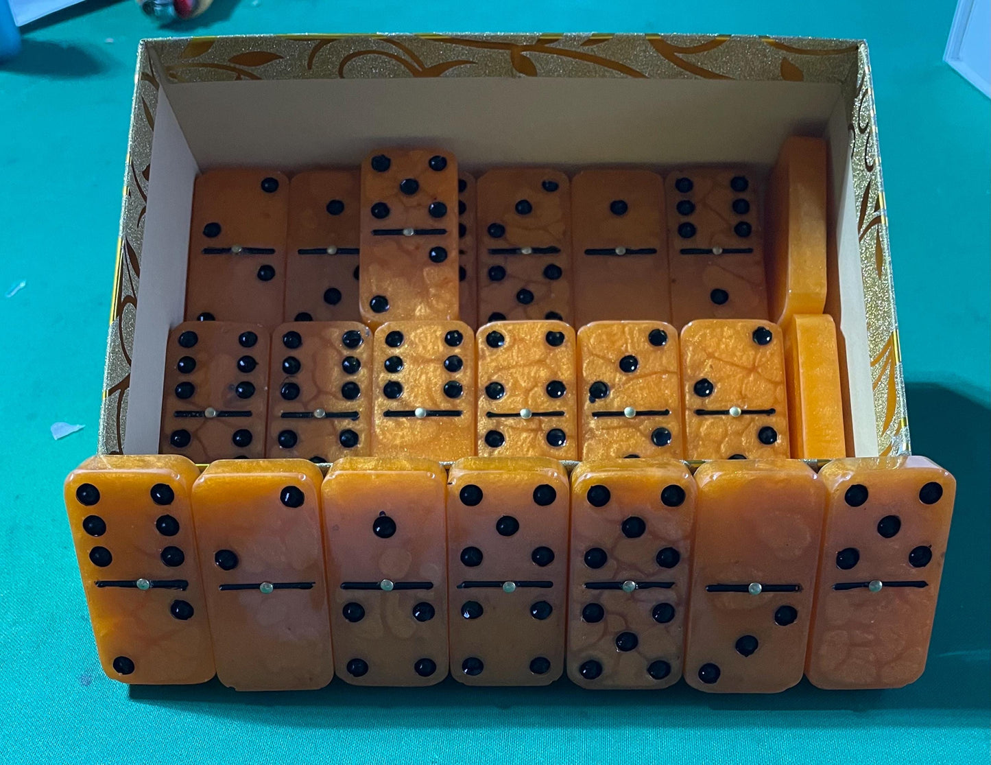 orange and black dominos—double 6/9/12 are available