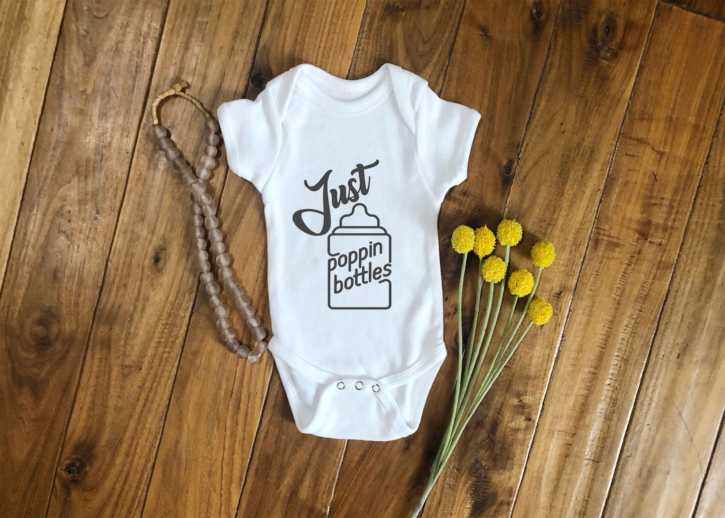 Poppin bottles graphic onesie